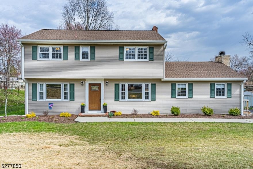 This Spectacular & Beautifully Appointed Center Hall Colonial is nestled in the desirable Troy Hills Section. Over half an acre with over 2000 square feet, this flowing, classic layout is great for entertaining or everyday living.. Foyer welcomes you in &  is bookended by a formal living room & dining room. Both boast large picture windows. Tons of natural light. Eat in kitchen w/granite countertops & stainless steel appliances opens to the large family room w/ wood burning fireplace. Convenient powder room & laundry. Gorgeous HW flooring, moldings & wainscoting. Upstairs 4 generous sized bedrooms & two full baths include a primary suite w/ en-suite & stall shower. Finished basement- bonus living w/rec room & den. Partially unfinished space w/workshop and provides storage along with attic & shed. Stunning Backyard Oasis- Perfect for Entertaining & Relaxation! Large Deck & Pool. Completely fenced in a large, level yard. Situated in a great location with easy access to all life's conveniences- close proximity to NYC-Direct train station, bus to Port Authority, shopping & parks. Walk to top-rated Parsippany schools. Easy access to major hwys. Meticulously maintained, shows true pride of ownership. Don't miss it!