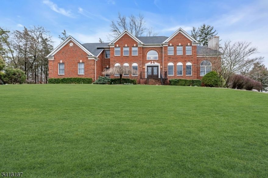 Nestled on a quiet cul-de-sac this exceptional home sits on a beautifully level 1-acre property, offering privacy, space, & timeless elegance. A sprawling patio overlooks the expansive, flat yard, creating the perfect setting for outdoor entertaining, relaxation, or future enhancements. Inside, the home is defined by an airy, open layout & striking architectural Details. The living room showcases dramatic vaulted ceilings, filling the space with natural light & a sense of grandeur, while the OPEN Second-floor hallway overlooks below, enhancing the home's expansive & connected design. The main level offers a seamless flow between the formal living room, elegant dining room, & a welcoming family room anchored by a fireplace, creating a warm & inviting gathering space. The gourmet kitchen, complete with a breakfast nook, serves as the heart of the home, ideal for both everyday living & entertaining. A first-floor bedroom with a private full bath provides flexibility for guests or a potential in-law suite. Additional spaces include a dedicated office & a refined library featuring its own fireplace, offering a sophisticated retreat for work or relaxation. The luxurious primary suite features a private sitting room or office & is further elevated by a spiral staircase leading to a dramatic multi-level library, creating a truly one-of-a-kind architectural focal point. Unfinished basement with walkout access presents endless possibilities for customization.