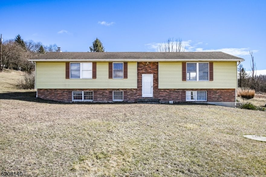 This is the starter home, easy fixer upper blank slate you've been waiting for.  This large bilevel is in great condition.  It features laminate floors and double sliding glass doors on the first floor.  Chimney is ready to accept new wood or pellet stove. Tons of room for entertaining downstairs plus full bath and potential office space.  Inlaw suite potential. Upstairs feels massive with an open kitchen dining room area adjacent to living room with picture windows overlooking the breathtaking country side views that go on for miles. Could be opened up more to make this house feel huge. 3 generous sized bedrooms and full bath upstairs. Exterior and interior are in great shape and clean bring your vision to put your finishing touches.