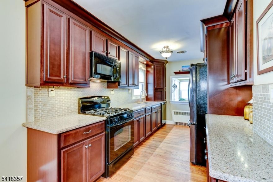 Nestled in a peaceful neighborhood, this highly desirable ranch-style home offers the perfect blend of comfort, style, and thoughtful upgrades, boasting over $100,000 in improvements. Featuring 4 spacious BR's & 2 neutrally renovated baths, this home is designed for effortless everyday living. A welcoming, open-concept Living & Dining area is enhanced by hardwood floors extending throughout the main living spaces & bedrooms. At the same time, energy-efficient windows complement the home w/ added comfort & savings. The remodeled EIK showcases stylish wood cabinetry, granite tops, a tile backsplash & newer appliances, flowing seamlessly into a bright, inviting sunroom/den. Outside, the backyard setting is complete w/ an in-ground pool featuring a new liner & pump (2025), along w/ a covered patio attached to the 2-car detached garage, which also offers a generous workshop space. Major updates provide peace of mind, including a new roof and AC (2024), plus a water heater & well pump (2025). Additional highlights include a whole house generator, 200 amp electrical service & public sewer. The partially finished lower level adds valuable living space w/ two separate finished areas serving a variety of uses, along with exceptional storage & a Bilco door for direct exterior access. Perfectly positioned adjacent to township-owned land and with all improvements properly permitted, this home delivers a wonderful suburban feel w/ convenient access to highways, schools, parks & shopping.