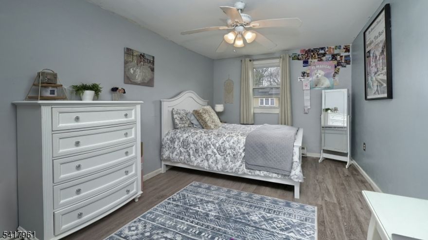 Dreams start here! Featuring a NEW roof and gutters (March 2026), this charming Cape in Wayne offers 3 bedrooms, 1 bath, and a detached garage. The main level showcases newer luxury vinyl flooring and a crisp white modern kitchen (2022) with stainless steel appliances, center island, and a separate dining room perfect for everyday living and entertaining. A sun-filled living room with a wood-burning fireplace adds warmth and character, while a main floor bedroom and updated full bath provide flexibility. A convenient mudroom with laundry leads to a fenced-in yard and patio, ideal for outdoor enjoyment. The second floor offers two additional bedrooms. Additional upgrades include windows, siding, and electrical, offering peace of mind for years to come. Situated in a quiet neighborhood near park, top-rated schools, and with easy access to highways and public transit, this home blends comfort, style, and convenience.