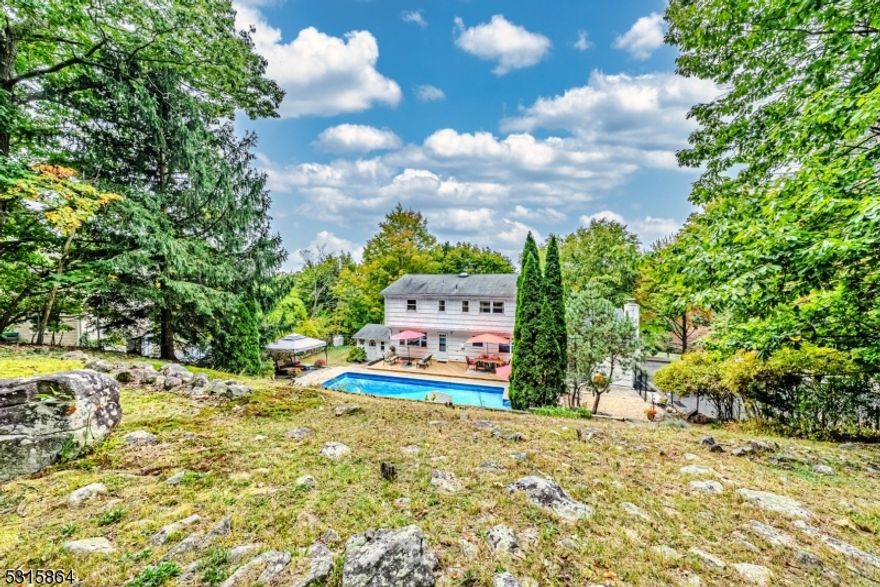 Welcome Home! Charming Colonial on over 1 acre of beautiful wooded, private corner lot in the Bald Hill/Kitchell Section of Denville. Pride of ownership shines! Immaculate & carefully thought through & cared for by the same owners for 20+ years. Lots of Generous Room Sizes to Spread Out & Make Your Own! This 2,300 sq ft Home has a Comfortable, Spacious Floorplan. Many Appealing Features Throughout. Gorgeous HW flooring & newer mechanicals! Just to name a few! First floor offers your classic & highly functional layout. Formal living room & dining. Bonus office space! The eat-in kitchen with gas cooking overlooks the backyard & family room with a WB fireplace. Powder room & mudroom/laundry. Upstairs, 4 generous sized bdrms & 2 full baths including the primary suite. Tons of bonus space in the full finished bsmt! Rec room area & plenty of storage! Large garden shed & a 2 Car Garage! Backyard OASIS -Perfect for Entertaining & Relaxation! Enjoy the stunning in-ground pool or lounge on the large deck. Fully fenced in! Level grassy lawn area alongside pool or stairs lead you to the perfect leveled space for another patio or playset (swing already included). An abundance of living space OUTDOORS & IN. Make this your year-round STAYCATION. Great home Situated in a great location w/easy access to all life's conveniences- close proximity to NYC-Direct train station, bus stops, shopping & parks. Enjoy bustling Dwtn Denville, Morristown, Boonton. Nat Gas line on street.