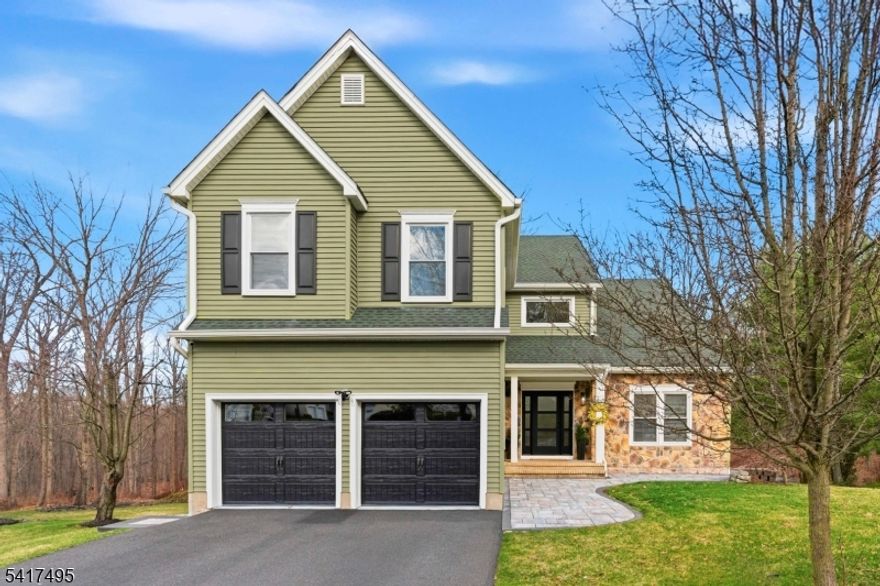 Elegance, comfort, and modern design come together seamlessly in this thoughtfully updated Colonial, perfectly positioned at the end of a tranquil cul-de-sac in the desirable Martinsville section. Every inch of this home has been enhanced with quality materials and stylish finishes, creating an inviting atmosphere inside and out. The main level showcases wide-plank white oak floors and an open, airy layout. A dramatic living room with soaring vaulted ceilings sets the tone, while the dining room offers custom-crafted built-ins for effortless hosting. The stunning chef's kitchen features quartz counters, glass tile accents, stainless steel appliances, and a pantry with convenient pull-out drawers. The adjacent family room centers around a cozy wood-burning fireplace framed in marble, making it an ideal gathering space. Upstairs, stylish newer carpeting provides comfort underfoot. All bedrooms are generously sized and equipped with custom closet systems. The impressive primary suite features a tray ceiling, two walk-in closets, and a private full bath. The walk-out lower level extends your living space with a finished area ideal for recreation or guests, complete with a full bathroom and bedroom/office. Step outside to enjoy a low-maintenance composite deck, a beautiful paver patio with firepit area, and sweeping views of Washington Valley State Park. Bridgewater offers easy access to major highways, premier shopping and dining, and is part of a top-rated school district.