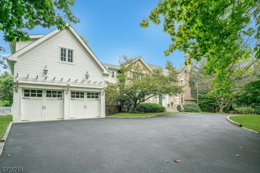 English Country charm meets Tuscan elegance in this 4-bed, 4.5-bath estate. Nestled on 1.45 acres a circular drive leads to this private oasis w/ gunite salt water pool, manicured gardens, bocce court, koi pond & several blue stone patios. Greeted by a two-story entry that flows into beautiful living spaces like a library w/ fpl and a sun drenched great room w cathedral ceilings and French doors that open to patio perfect for entertaining. The EIK has high end appliances and an island w/seating. The DR, w/large bay windows, provides an elegant setting. The 1st flr also incl. a LR w/fpl, built-in bar & outdoor access, office w/full bath, ldry/mdrm and PR. Upstairs there are 4 bedrooms including a primary suite w spa-like bath w/ marble vanity, shower & jacuzzi, secondary en suite w lndry located in a private wing accessible via a back staircase or elevator. Home also incl. a wine room, gym & 5 car garage! Don't miss this special home a decorator's dream!