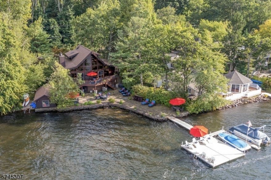 Experience lakefront living at its finest in this exquisite Lindal Post & Beam 3 bedroom, 2.5 bath retreat on the shores of pristine private Green Pond, NJ's cleanest lake. Special features abound, from the warm ambiance of a wood-burning stone fireplace to the grandeur of floor-to-ceiling windows that bathe the great room in natural light. The gourmet kitchen boasts top-of-the-line amenities, including a Subzero & Wolf appliances, central island, and luxurious quartz countertops. Two bedrooms grace the main living floor, while the primary bedroom enjoys an ensuite sanctuary on the second level.The lower level is a haven for relaxation and recreation, featuring a pool table and a versatile bunk room combination. Step outside to an expansive lakefront blue stone patio, ideal for hosting gatherings. Here, you'll discover a fire pit area, an outdoor bar, and two welcoming outdoor dining spaces. Take in breathtaking sunsets over Green Pond's western shore from the new floating dock system.Enjoy modern amenities, including all-new baths, wood floors, a full-house generator and so much more! A decommissioned boathouse, offers possibilities for conversion into a charming bunkhouse or an additional entertainment hub. This property comes fully furnished, complete with a pontoon boat, ski boat, and water toys, promising endless lakefront adventures. Golf cart friendly Green Pond is only 1 hour from NYC. Activities include tennis, pickle ball, motor boating, sailing & more!