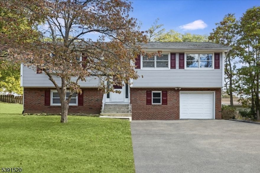 Beautifully updated and move-in ready, this 3-bedroom, 2-bath, two-level home offers modern style and flexible living just moments from the lake. The open-concept upper level features a bright living area that flows seamlessly into the dining space and a sleek, modern kitchen perfect for everyday living and entertaining. Three comfortable bedrooms and a full bath complete the upper floor. The spacious lower level adds versatility with a large family room, home office or potential guest suite, full bathroom, and convenient laundry area with direct garage access. Enjoy outdoor living on the deck overlooking the yard ideal for relaxing or hosting gatherings. With electric heat, central air, and all appliances included, this turnkey home combines comfort, convenience, and location in one attractive package. Set in a desirable neighborhood near the lake and local amenities, this is an opportunity not to be missed!