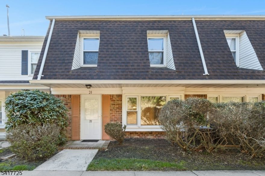 Welcome to 28 Wareham Court, a beautifully refreshed three level townhome offering over 2,000 sq ft with 2 bedrooms, 2.1 baths, and an attached garage. Freshly painted from top to bottom, including the garage, and featuring brand new stain resistant carpeting throughout, this home presents a clean, updated, move in ready interior. The first level includes a sun filled den with a wood burning fireplace, a kitchen with quartz countertops, custom pantry closets and stainless steel appliances, a separate dining room, spacious living room, and powder room. The layout offers a very comfortable flow for daily living and gathering. A private patio provides space for outdoor lounging, grilling, and plantings. Upstairs, the primary suite features a skylight, two enormous walk in closets, and a private en suite bath. The second bedroom also offers a walk in closet and next to the full hall bath and laundry room. All three bathrooms have been updated, including the second level hall bath with a jetted tub. A large private third floor loft, approximately 21x19 with a skylight, offers flexible bonus space for a home office, gym, or retreat. Enjoy resort style living on over 60 acres with a 24/7 attended gatehouse, pool, tennis, pickleball, clubhouse, and beautifully maintained grounds. Pet friendly and just one block to NYC bus, close to shopping, dining, parks, and major highways, with full day kindergarten and school bus service. Only 20 miles to Manhattan.