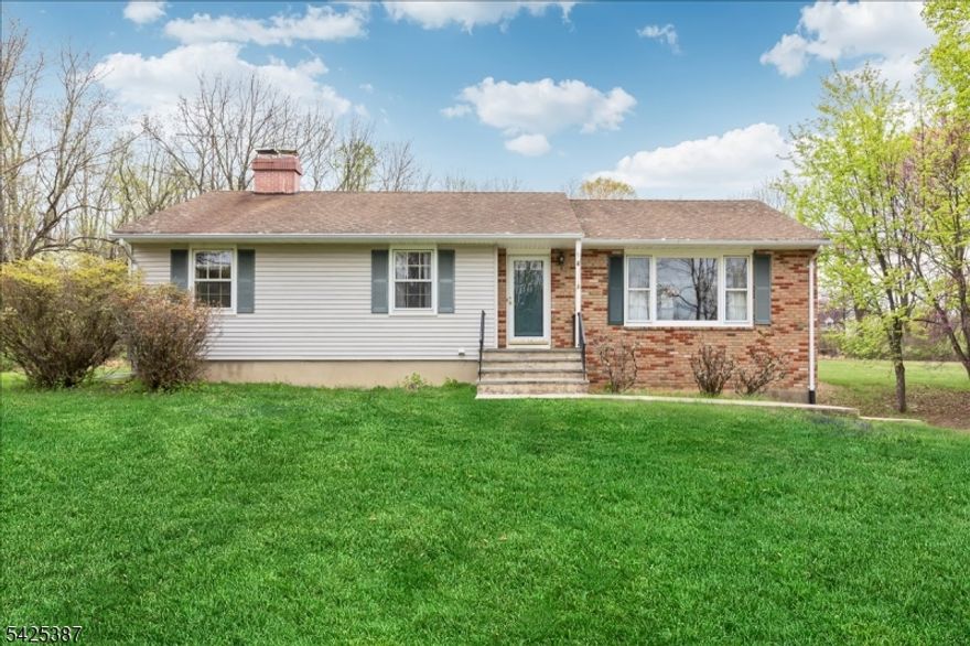 Traditional custom ranch all ready for a quick close on a spectacular 2.81 acre open & level lot. Set back from the road for privacy a long driveway takes you to this amazing home. A walkway leads you to the covered front porch. Step inside to the welcoming foyer with coat closet opening to the large living room with hardwood floors & picture window. A desirable open concept has the living room flowing into the wide dining room with another oversized window. The eat-in kitchen features wood cabinetry, stainless steel appliances & door to deck & yard perfect for parties & barbecues. The roomy primary bedroom has hardwood floors, double closets & an en-suite full bath with stall shower & new white vanity. Secondary bedrooms have hardwood floors, ample closet storage & are conveniently located near the main bath with tub shower. Spacious family room centered on a brick surround wood-burning fireplace makes a great recreation or playroom. Attached over-sized 2-car garage. Incredible sprawling lawns surrounded by trees & shrubs for privacy. This tranquil 2.81 acre lot near shopping & dining is also close to commuting Routes 78, 31, 57 & bus/train service. Perfect for outdoorsmen & naturalists this home is located by numerous local parks & recreation areas including the nearby Musconetcong River & Point Mountain Preserve. Popular Lebanon Township school district which includes prestigious Voorhees High School.