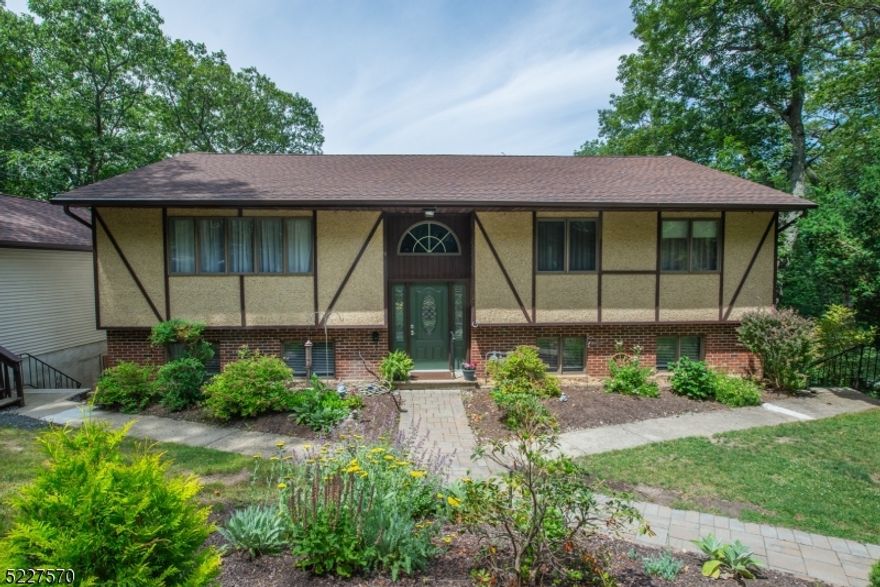 Immaculate, Custom Bi-Level located in Erskine Lake. Located on a large, private, wooded lot in Great Neighborhood. Lots of Generous Room Sizes to Spread Out & Make Your Own! Layout offers versatile options! GREAT house for entertaining or everyday living. Large living room & formal dining room with slider to back deck. Bright, eat-in kitchen- granite countertops & glass tile backsplash. Abundance of high hats & large windows -Lots of light! 3 large bdrms & 2 renovated full bath upstairs includes the primary suite w/bath (walker accessible stall shower). Oak hardwood flooring throughout. 3 additional office/den/flex rooms on lower level. Fully equipped w/the third full bath. Kitchenette area with separate entrance. Family room walks out to the lower deck. Convenient laundry/mudroom. Oversized detached garage. Over 2800 sqft of living. Seasonal Lake views. Tons of parking! 3 quarters of an acre. An ideal spot to relax on the deck & enjoy life amongst the tree line. Erksine Lake living! With membership, enjoy all the amenities- swimming, beaches, fishing, boating, sailing & more! Easy access to shopping, restaurants and Library on Skyline Drive or Wanaque. Top rated community with excellent schools! Natural gas and public water, tons of cosmetic upgrades already done!