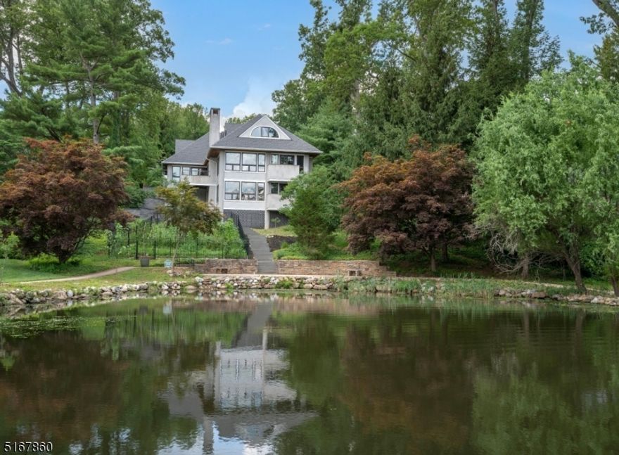 Sun filled lakefront with sweeping views of idyllic Mountain Lake, this freshly painted custom home has a striking open floor plan and unique architectural features, creating fabulous entertaining spaces throughout. The lake cove at your backyard provides an easy access for water activities. Enjoy swimming, fishing, sailing, kayaking, canoeing or ice skating from your back door! Both the first floor living room and lower floor family room have wall to wall windows highlighting the lake views, wood burning fireplaces, wet bars with a sink and beverage fridges. The gallery overlooking the living room is a perfect multi purpose space! The kitchen has custom oak cabinetry with a corner window overlooking the lake, an island with breakfast bar and access to the upper bluestone patio. It is adjacent to the dining room which boasts coffered ceilings and large windows. The first floor primary bedroom suite has plentiful closet space. Don't miss the large laundry room off the oversized 2-car garage, private bedroom balconies, walk-in cedar closet, central vac, and built-in generator. Conveniently located close to major highways, public transportation, restaurants, shops and an excellent school system, this home has it all!