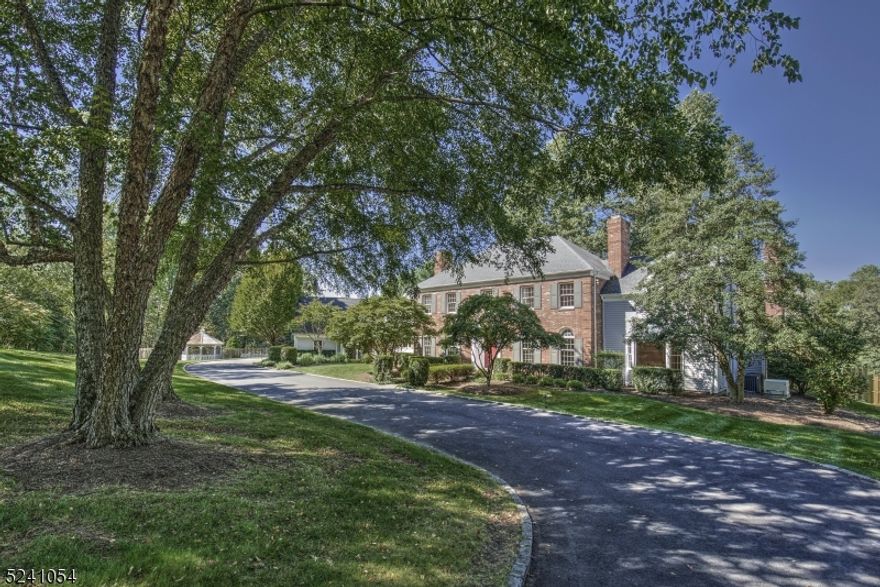 The peaceful setting off a private road in the treasured Pleasant Valley portion of Bernardsville complements this classically-styled home. Ideally designed to offer a variety of multi-generational living options, the 7,000+ sq ft interior provides rooms of generous size and tasteful appointments. Arched entries and a delightful gallery across the back open directly to a broad brick terrace and views of the landscaped back yard. The front-to-back foyer and handsome staircase set a gracious and welcoming tone that carries throughout the public rooms. The kitchen opens directly to an expansive  Family Room with fireplace viewed from both areas. The Library and a Den/Office at the end of the first floor gallery hall share a wet bar with wine fridge as well as a powder room, the area set off perfectly for a future guest suite. The primary suite and 3 secondary bedrooms and 3 full baths are located on the second floor. A study/office links to one bedroom and offers use as a potential suite.  The 4th bedroom is also a Bonus Room or in-Law suite with entries off the first floor back hall and links directly to the second floor.   The basement is unfinished.  The home is surrounded by gorgeous 5-acre grounds with specimen plantings and a fully fenced back yard. A free-form Gunite pool and gazebo-style pool house enjoy their own privacy in the lush side yard. 5 fireplaces and chimneys are lined and offered as-is with no known problems. Square footage as per tax records.