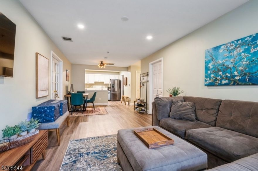 Spacious townhouse in a peaceful setting close to everything!  Live the lifestyle you've dreamed about in this immaculate  2 bedroom,  2 bathroom townhome tucked into the beautifully landscaped and gated Cambridge Heights complex. With a pool and fitness center, this community is just minutes to parks, shops, restaurants, major highways, the Delawanna train station, and the bus stop for an easy commute to New York City.  Highlights include new floors and windows, recess lighting, abundant natural light, a patio, and generous closet space. Beyond the foyer with a full bathroom and two closets, the open layout flows into a large, sun-filled living room with sliding glass doors to a cozy, partially covered patio. The dining area is adjacent to the large, open kitchen equipped with granite counters, ample bright white cabinets, and new stainless-steel appliances. French doors open to a spacious primary bedroom with two large closets and a full en suite bathroom, while the second bedroom features a bay window and convenient inside access to the full hall bathroom.  Move right in and enjoy luxurious, low maintenance living in this unbeatable location!