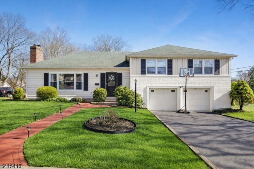 Welcome to this beautifully updated 3-bedroom, 2-bath split-level home located on a spacious corner lot in the desirable Countryside section of Hackettstown. This inviting home blends classic charm with modern updates and offers a comfortable layout ideal for everyday living and entertaining. The sun-filled living room features gleaming hardwood floors, large picture windows, elegant designer light fixtures, and a stunning modern stone fireplace feature wall. The space flows seamlessly into the dining area, creating a bright and welcoming atmosphere. The updated eat-in kitchen boasts rich cabinetry, quartz countertops, stainless steel appliances, stylish pendant lighting, and a breakfast peninsula perfect for casual dining. Upstairs you'll find three spacious bedrooms and two full bathrooms, including an updated main bath and a primary bedroom with its own bath. A versatile den provides flexible space for a home office, playroom, or additional living area. Additional highlights include a two-car built-in garage with inside entrance, unfinished basement for storage or future expansion, 4-car driveway, and a paver patio ideal for outdoor entertaining. Renovations completed in 2023 include EIK, main bath, boiler, doors & refinished hardwood floors. New VLP flooring in the den. Located just minutes from Downtown Hackettstown, this home offers easy access to restaurants, shops, parks, and NJ Transit train station, along with convenient proximity to Routes 46 and 80 for commuting.