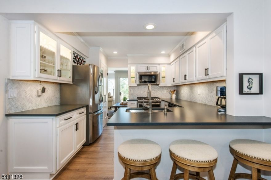 Beautifully renovated and offering stunning mountain views, this unique townhome is located in the highly desirable Stone Edge community. The upper level features two spacious bedrooms and two updated full bathrooms, complemented by hardwood floors, custom crown molding, a skylight, and a convenient laundry area. The updated kitchen shines with brand-new stainless-steel appliances, glass-front cabinet doors, a breakfast bar, new flooring, a separate dining area, and plantation shutters. The inviting living room includes a new gas fireplace, ceiling fan, and ample space for entertaining. Large sliding glass doors open to a private deck perfect for enjoying the breathtaking views. The lower level offers a generously sized, fully finished space with its own full bathroom and private walk-out, making it ideal as a bedroom suite, guest quarters, or flexible living area. Enjoy pool and tennis which is all part of this private community. All located to nearby downtown areas