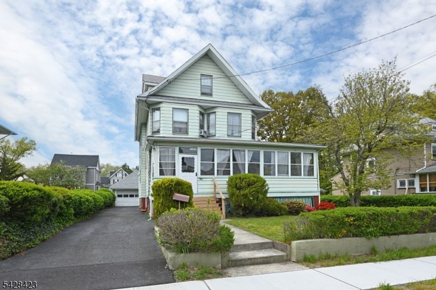 Turn-of-the-century Colonial-style home, situated on an oversized lot. Offering 5 bedrooms and 3 full baths. Features natural woodwork and hardwood floors throughout. Spacious layout with bright, generous-sized rooms. A finished bedroom in the attic and an additional unfinished space for a possible primary suite. A wide front porch enhances curb appeal and provides a welcoming entry. Park-like yard offers ample outdoor space for recreation and entertaining. Located on a tree-lined street near parks, schools, and bus to New York. Detached 2-car garage with additional parking for up to 4 cars. Strong potential for customization and value-add opportunities.