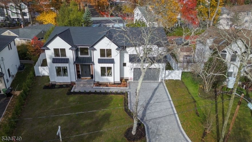 This is truly one of the finest homes currently on the market an extraordinary new construction estate in the highly sought-after, low-tax town of Paramus. Offering over 7,400 square feet of impeccably designed living space on an oversized lot, the residence masterfully blends refined elegance with modern functionality.From the grand two-story foyer with herringbone flooring and custom millwork to the soaring 10-foot ceilings and white oak hardwood floors throughout, every detail showcases exceptional craftsmanship. The chef's kitchen with Viking appliances, custom cabinetry, and a sunlit breakfast nook flows seamlessly into the formal dining room with a wet bar and an expansive backyard with room for a pool. A first-floor bedroom suite, private office, and powder room complete the main level.Upstairs, the luxurious primary suite features two custom walk-in closets and a private balcony, accompanied by four additional bedrooms and a convenient laundry room. The fully finished lower level with 9-foot ceilings offers a gym or theater space, an elegant wine room with a hidden wine cave, a great room with a wet bar, and two additional bedrooms with a full bath.With heated floors, floating vanities, high-end finishes, and full smart-home prewiring, this residence delivers both sophistication and modern convenience in one of Bergen County's most desirable communities.