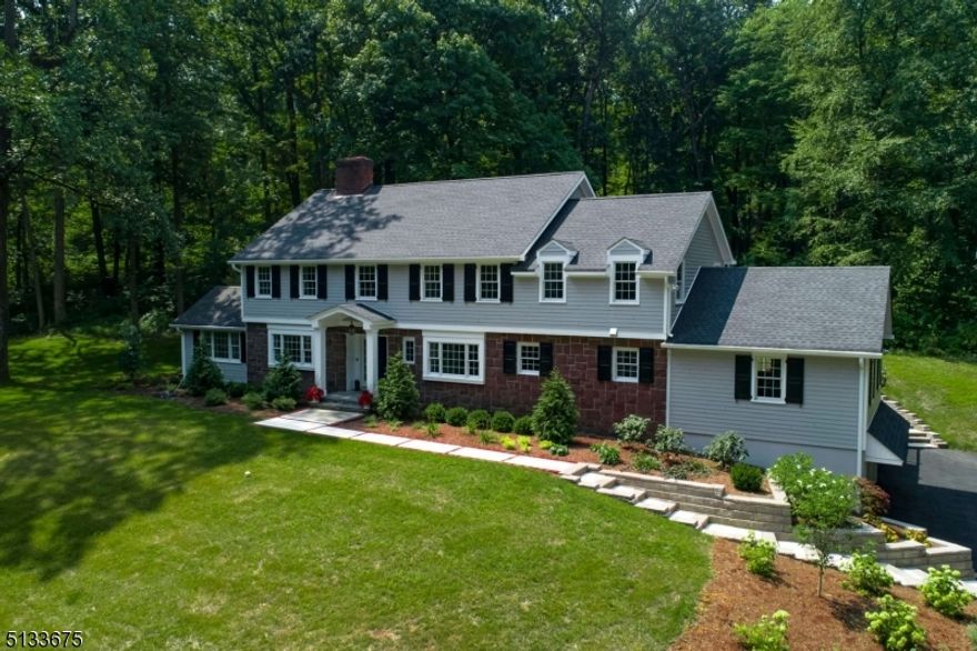 Welcome to this completely renovated center hall Colonial located in an exceptional Harding neighborhood. This 6 bedroom 4.2 bath home is sited on 3+ acres. Hardwood floors, custom moldings & spacious rooms are showcased throughout.  The gourmet updated kitchen with quartz countertops, top of the line JennAir appliances and breakfast area. The formal Living room features a wood burning fireplace, leads to a bright sunroom with wet bar and doors to a private terrace. The spacious family room also includes a wood burning fireplace and vistas of the yard. The sun filled formal dining room with door to deck, is spacious and ideal for entertaining. The laundry room is off the kitchen. An ensuite bedroom is also located on the first level leading to french doors and another access to the Trex deck. A powder room is off the front hall. On the second level the primary bedroom has a stunning tray ceiling, a large walk in closet, ensuite bath with Carerra marble, custom tub and also a large shower. Four additional bedrooms with large closets and two additional bathrooms complete the second floor. The lower level offers a large finished recreation room, utilities, storage, half bath and access to 3 car garage. This prime location is convenient to excellent schools, NJ Transit, major highways, shopping and dining.