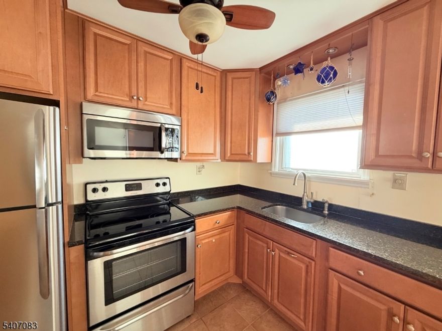 Immaculate second-floor condo in Mountainview. The updated kitchen features wood cabinetry, black granite countertops, stainless appliances and a full-size washer and dryer. Enjoy a large LR / DR and a generous sized bedroom with walk-in closet. This end unit location offers plenty of windows, and a rear door off of the kitchen that leads directly to the parking lot and basement storage. Excellent location with easy access to shopping, major highways and public transportation. Whether you are a first-time buyer or downsizing, this move-in-ready home is a must-see. *New Hot Water Heater 1/26