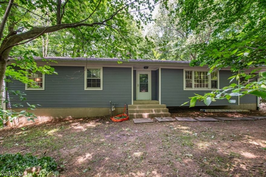 Welcome home to this 4 bedroom ranch located on a quiet cul de sac with a serene, 1 acre, woodland setting! Eat-in kitchen with peninsula updated in 2017 with granite countertops and stainless steel appliances. Home complete with public utilities, natural gas hook up, hardwood floors, recessed lighting, separate dining room, built in living room cabinets, primary bath, 2 car garage and finished walkout basement perfect for entertaining with a large bar and fireplace for ambiance. Take advantage of top rated Long Valley school systems.