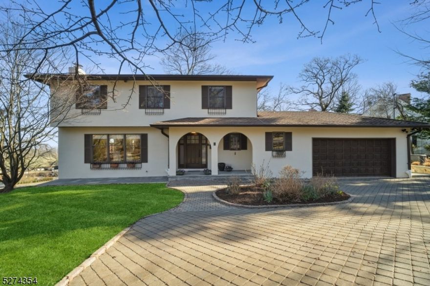 This stunning home, situated on half an acre, offers breathtaking views of the New York City skyline. Fully updated, the main level boasts a bright gourmet kitchen equipped with top-of-the-line appliances that seamlessly opens onto an expansive deck. The spectacular, sun-filled great room features a vaulted ceiling, a wall of windows, and a dramatic stone hearth gas fireplace, flanked by built-in cabinetry. On this level, you'll also find a formal dining room with its own fireplace, a cozy living room also with NYC views, a powder room, laundry, and direct access to the two-car garage for added convenience. Heading upstairs, a beautiful primary suite complete with a newly updated bath featuring a soaking tub and a custom walk-in closet awaits. Additionally, there is another gorgeous full bath and two more generously sized bedrooms. The lower level of the home offers even more living space, including a full bath, a sitting room, an exercise room, and another bedroom/office with a separate entrance. This unique property provides ample storage, a whole-home generator for peace of mind, and the epitome of luxury and privacy. Plus, it is perfectly situated close to all that Montclair has to offer.