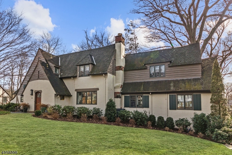 Modern luxurious appointments seamlessly paired w/timeless traditional architecture in this meticulously maintained home w/flowing floor plan&1st floor guest suite.Over 1/3 acre of impeccable grounds. Large dining rm w/arched doorways,leaded glass windows paired w/cool transitional decor.Living rm w/Stone FP,Mahogany library w/high gloss finish+custom built ins,Glass Amdega conservatory has heated floors.Chef's kitchen w/black Viking range,Subzero,Custom cabinetry+breakfast rm w/built-in banquette.Master Suite fully re-imagined&tailored for modern living w/spa bath,high beams,dressing rm w/fitted walk-in closet,breakfast bar w/wine fridge&laundry.Two add'l BRs+hall bath finish 2nd fl.The lower level has open family/media rm+custom office space.Backyard w/Stone patio&Play area.Ideal location to NYC train+town
