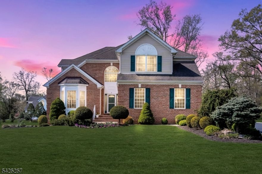 Nestled on a quiet cul-de-sac in one of Bridgewater's most sought-after neighborhoods, this quality-built 2002 brick-front Colonial offers 5 bedrooms and 2.5 baths with timeless craftsmanship and thoughtful upgrades. A dramatic high-ceiling foyer and cathedral ceiling living room create an elegant first impression, filling the home with abundant natural light. The freshly painted interior features hardwood flooring throughout, architectural columns, and upgraded lighting.The upgraded kitchen showcases 42" cabinetry, a brand-new gas range with vented hood, newer stainless steel appliances, Corian countertops, a center island, breakfast area, and pantry, and opens to a step-down family room with access to a 20 16 deck ideal for entertaining. A first-floor bedroom offers flexibility for guests or a home office. The expansive primary suite features vaulted ceilings, an airy en-suite bath, and generous closet space. Three additional bedrooms, an open hallway, and a second-floor laundry room complete the upper level.Additional highlights include newer HVAC and hot water heater, central vacuum, gas fireplace, a newer driveway, and a basement with 9-foot ceilings offering excellent potential for additional living space. A side-entry finished garage with windows adds both function and appeal. Enjoy a large level backyard backing to woods, a custom deck, professional landscaping, and a sprinkler system. Convenient to top-rated schools, parks, shopping, dining, and major highways.
