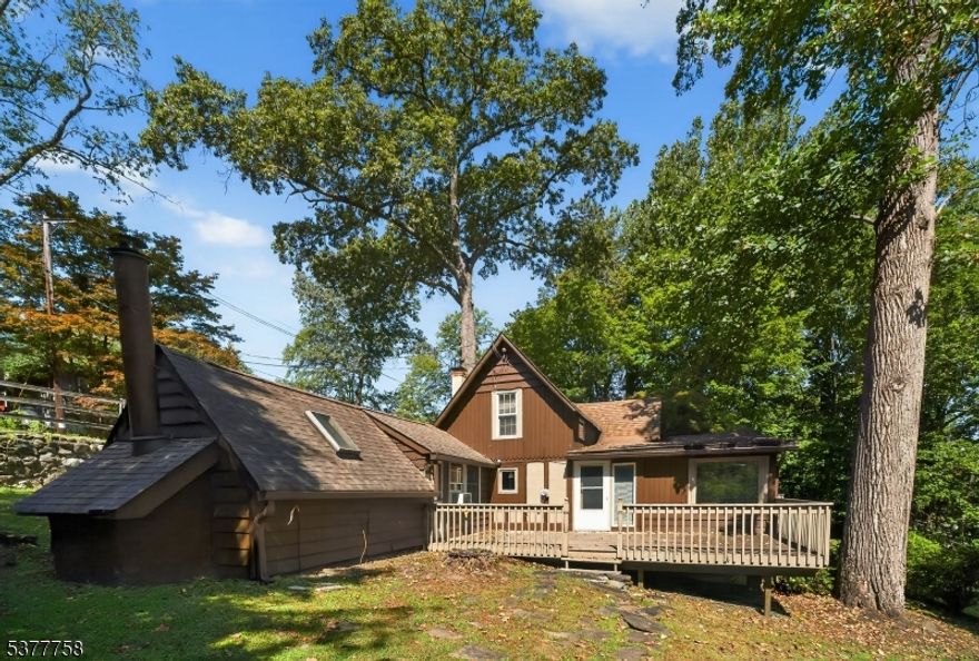 Live every day on vacation in this Crane Lake-style home located on over .5 acres in picturesque Lake Mohawk near Beaches 5 & 6. Enter this truly unique Lake-style home and view the soaring beamed ceiling, many oversized windows and a cozy stone fireplace. All creating an inviting atmosphere to enjoy nature or snuggle up in front of the fire. This 4 Bedroom, 3 Full Bath home has room for everyone whether you are searching for a year-round home or a seasonal get-a-way. This home features hardwood floors, a pecky cypress ceiling in the Living Room and Dining Room and a wide spiral staircase. The Family Room offers a wood burning stove and access to the oversized deck. Enjoy a private Deck off the Primary Bedroom. New septic 2021.The Lake Mohawk Country Club offers dining and event spaces overlooking the lake. Enjoy a cocktail at the club and watch the stunning sunset over the lake. Sparta is 1 hour from NYC. 30 minutes from Ski resort and water park, (Mountain Creek). 30 miles from Delaware Water Gap.