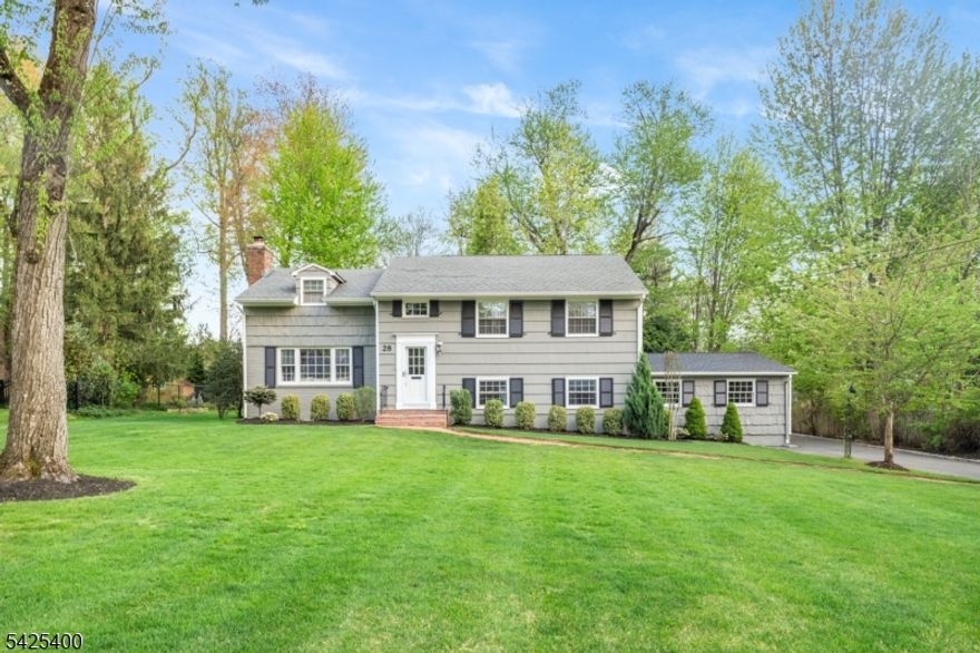 28 SPRING RIDGE  NOW THIS ONE IS SPECIAL! Light pours into every room of this updated 4-Bed, 3-Bath custom home, thoughtfully crafted, nestled on a serene street with contagious curb appeal. As you enter the immaculate Living Room, embrace the wood-burning fireplace with striking herringbone tile, flanked handsomely with custom-built display shelves for your favorite books or art. The open Eat-In Kitchen and Dining Room instantly captivates you, with bespoke shaker cabinetry, quartz countertops, large center island with modern pendant lighting, LG stainless appliances; plus, a cushioned bay nook that invites you to linger in the natural light, while also enjoying the charming red brick gas fireplace that feels delightfully cozy. Continue through either a French or unique Dutch door to magnificent Sunroom, a tranquil sanctuary  or gathering hub, adorned with four glass sliders to a massive deck and spacious Backyard, an entertainer's dream! Downstairs, a snug Family Room begs for memories, clad in rich wood paneling and beamed ceiling, with a stunning, stacked Wet Bar, and walls of built-ins. Plus, newly finished Basement with chic fireplace and storage, is ideal for Recreation/Gaming Room. Three bright Bedrooms, and 3rd Level Primary "Retreat,  boasting two huge closets, a cedar "bonus  room perfect for Home Office or Exercise, and skylit Ensuite with dual vanities, complete the interior. Great location! Quiet street, walk to school, minutes to train  and ready for YOU!