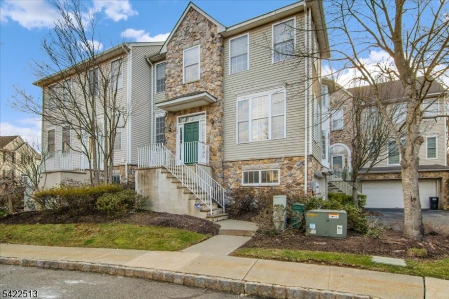 Beautifully renovated 3-bedroom, 2.5-bath end-unit townhome with a 2-car garage in the highly desirable Arrowgate community of Randolph. The main level features a newly tiled foyer and an open-concept layout with freshly polished hardwood floors throughout. The updated kitchen offers stainless steel appliances, granite countertops, a pantry, and overlooks the family room with a gas fireplace and direct access to a private deck perfect for entertaining. The second floor features hardwood floors throughout and three generously sized bedrooms, including a spacious primary suite with a large walk-in closet and a fully renovated en-suite bath with a soaking tub, stall shower, and dual LED mirrors. A fully renovated main hall bathroom completes the upper level. The finished lower level offers a versatile recreation room with new flooring, a laundry area, and direct access to the newly painted attached 2-car garage ideal for storage, a home office, or media room. Enjoy community amenities including an outdoor pool, playground, tennis courts, and pickleball courts.