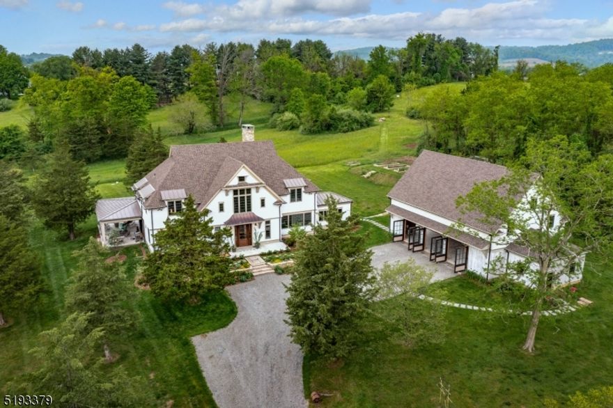 Stroll to breakfast, fine dining and shopping in an idyllic country town, and enjoy all of the peace of country living.  Situated on over twelve acres in the quaint village of Oldwick, only 45 minutes by car to the tunnels, this Tewksbury gem is three miles from I-78.  The modern, elegant farmhouse completed in 2017 by the designer/architect owners, features expansive views and privacy from a one-of-a-kind wrap-around porch.  Custom detailing inside and out, fine finishes, a chef's kitchen, and a bespoke barn (2019) with kitchen, half bath and guest suite are some of the hallmarks of this home, built for entertaining and solitiude.