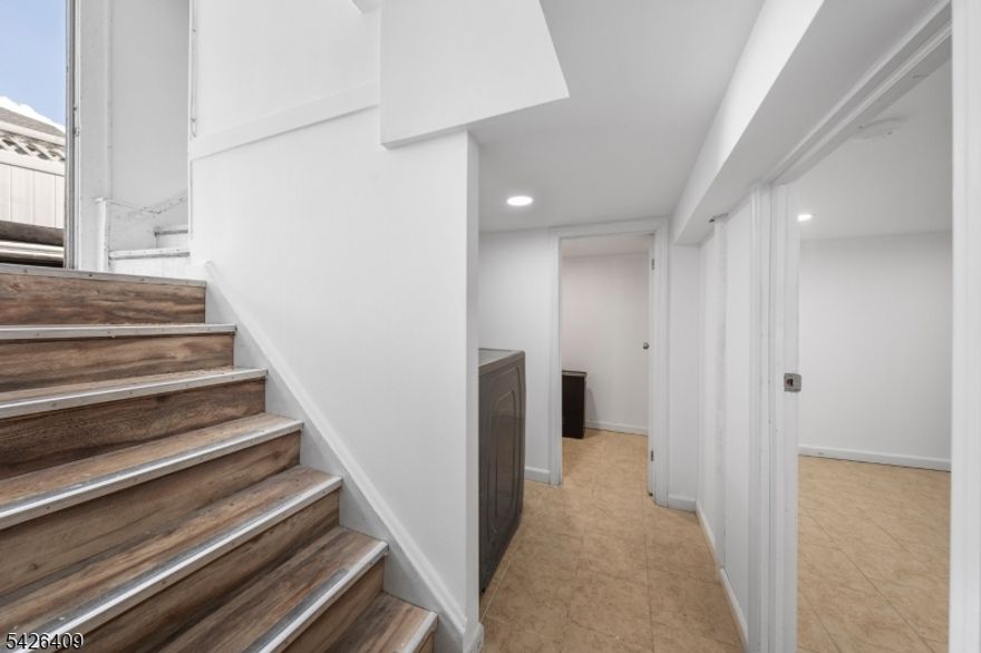 The house you were waiting for, finally is here!!! This beautiful renovated Colonial style house is located in the Elmora section of Elizabeth. 3 nice size bedrooms with 1.5 bathrooms and additional room in the first floor that can be used as an office or storage. Separate and huge living and dinning rooms. Finished attic and finished basement with private parking space for at least 6 cars. Deep backyard with a nice deck just to enjoy for this coming summer. Close to Kean University, public transportation, restaurants, stores, schools and just 5 minutos to the Newark Airport and Elizabeth Train Station.