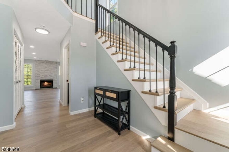 Stunning- completely updated end unit w outstanding location and direct entry garage.  All new, eat in kitchen with granite countertops & ceramic tile  backsplash  and stainless steel appliances.  All new  2.5 baths , all new flooring, 2 story foyer w new custom banister, new lighting, new stone surround for fireplace, new sliders to patio, new Thermopane windows .  Great location adjoins open space . No side neighbors and near guest parking .