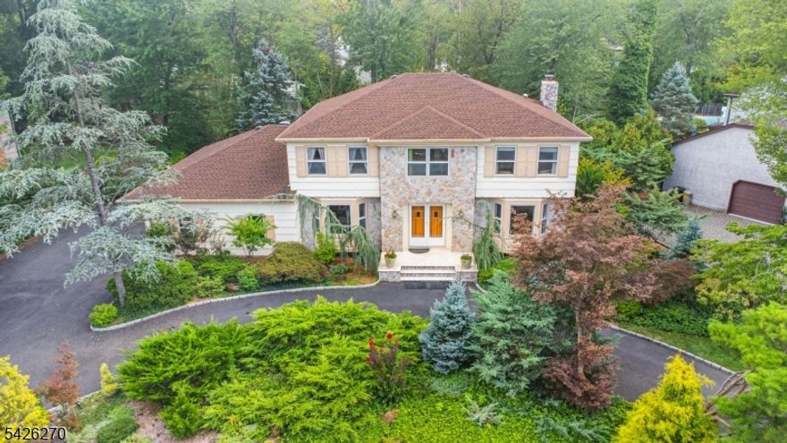 Welcome to this stunning Colonial located in a highly desirable neighborhood & set on a beautifully professionally landscaped lot, this home boasts a tranquil oasis in the backyard, featuring a serene pond, soothing waterfalls & a two-tiered deck perfect for entertaining or relaxation. A bright glass SunRm completes the outdoor paradise. As you enter the 1st floor, you're greeted by a center foyer w/beautiful marble floor & spacious formal living & dining rms,perfect for both casual & formal gatherings.The FamRm is accented w/a fireplace & offers easy access through a slider to the deck,creating a seamless flow between the interior & exterior.The large eat-in kitchen is a chef's dream w/center island,great counter space & a handy pantry.A convenient 5th BedRm/office completes the 1st floor,offering flexibility for your lifestyle.On the 2nd floor,a primary suite provides a private retreat,featuring a full bath w/jacuzzi,spacious walk-in closet & balcony overlooking the rear yard a perfect spot to unwind.3 other generously sized BedRms & full bath w/jacuzzi offer ample space for everyone!The entire home is light & bright,thanks to skylights that flood the rooms w/natural light,creating an inviting atmosphere!A FinBSMNT adds more living space w/full bath,storage & Jacuzzi.This home is the perfect blend of style,comfort & functionality,offering everything you need for modern living in a beautiful, serene setting.Don't miss out on the opportunity to make this your dream home!