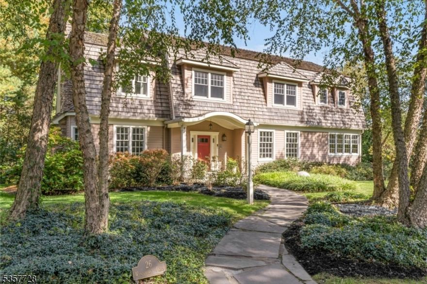 Welcome to 26 Wyndehurst Drive, an architectural masterpiece by Gertler & Wente Architects situated in Madison's desirable Hill section. This exceptional residence spans 5,400 square feet, harmoniously blending timeless elegance with modern luxury. Upon entry, exquisite designer lighting fixtures create a refined atmosphere throughout while architectural ingenuity shines with a distinctive turret and meticulous details adorning each room, infusing unique character and allure. For culinary enthusiasts, the gourmet kitchen is a haven of epicurean delights, featuring a commercial-grade pizza oven that is perfect for creating delectable dishes while a 1,000-bottle wine cellar awaits for your prized vintages. A first floor bedroom suite/home theater, large lower level recreation room and five upstairs bedrooms, sitting room and expansive private office offer plenty of space for all. Outside, an exquisite ipe deck offers panoramic views of manicured landscapes, perfect for intimate or grand celebrations. Streamlined convenience is at the core of the design philosophy, enhancing daily living with understated elegance. Strategically positioned, this home offers easy access to downtown amenities, the NJ Transit train station and renowned private and public schools, providing a well-connected lifestyle without compromise. Your opportunity for unparalleled living awaits in this meticulously crafted haven of comfort and elegance.