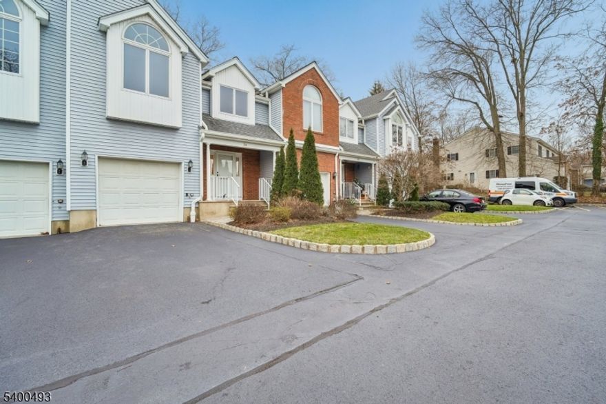 Spacious Town Home in private Madison Estates. Covered porch, foyer entry with guest lavatory, first floor full size laundry/pantry and one car built in garage access with auto opener. Newly refinished hardwood floors in this open & versatile floor plan that flows nicely into formal dining room, large, eat in kitchen with sliders to rear deck, sunken living room with cathedral ceilings, skylights and additional slider. Don't need formal dining room? Room can easily be used as family room because of large eat- in area in kitchen.  Very spacious second floor primary bedroom with walk in closet, private ensuite bath with skylights, double vanity, soaking tub and water closet with stall shower & commode for added privacy. Two additional bedrooms with double closets, high ceilings along with hall full bath & linen closet. Lower Level is unfinished and great for storage. Lawn care, snow removal included. Located in bucolic Madison with it's downtown shops, restaurants, conveniently located for easy access to Manhattan Direct Train/Bus line, nearby schools, parks & highways. Freshly painted throughout, hardwood floors refinished, carpets professionally cleaned. Ready to move in!