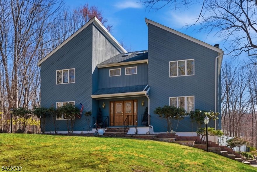 This home truly has it all and checks every box! Featuring 5 bedrooms and 2.5 baths.  This impressive property sits on nearly 2 acres of flat, level, wooded land, offering both privacy and space. Inside, you'll find hardwood floors throughout, a spacious living room and family room both with fireplaces, and a formal dining room perfect for gatherings. The cozy three season sunroom sits off of the expansive kitchen, where you can relax and enjoy peaceful scenic views. First floor bonus room/den offers flexible square footage, ideal for a home office, guest space, or media room. Additional features include multi zone central air and heating, central vacuum, and a whole-house generator for added comfort and convenience. The primary suite boasts cathedral ceilings, a private office or nursery, a walk-in closet, and a large split bathroom, designed for both function and luxury. Full unfinished basement with entrance to an over sized, 3 car garage completes this exceptional home. Step outside to your own private retreat with a fenced-in backyard, heated in-ground pool and a multi-level deck ideal for entertaining. Conveniently located approximately 45 miles from NYC and just 14 miles from Mountain Creek Ski Resort & Water Park. Preview Sparta's highly ranked public and private schools. Close to lakes, parks and public transportation to NYC. Don't miss this opportunity to own this one of a kind home!
