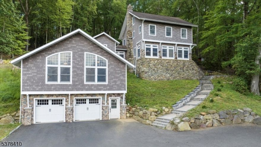 From a small hunting cabin to "The House On The Side Of The Mountain" - designed by Zimmerman Architects of Denville. With attached Guest Suite, possible home office use or a retreat home. Discover the perfect blend of timeless craftsmanship and modern comfort in this beautifully rebuilt 2024 home, nestled into its natural surroundings, backs to the 550 acres of Tourne County Park. Inside, natural light pours through expansive architectural windows and skylights and enjoy the scenery of the Rockaways. Chef's kitchen, featuring high-end appliances, custom cabinetry, gleaming white stone countertops with matching backsplash, a sleek undermount stainless-steel sink an ideal setting for the home cook or entertainer. The living room has a striking natural stone wood-burning fireplace with original  chimney and stone walls creating both rustic, warmth and sophistication. Fine details abound with solid wood Craftsman-style doors, oak railings with wrought iron accents, exquisite stonework and gleaming hardwood floors throughout. The primary suite offers a serene escape with an ensuite bath and spacious walk-in closet. A versatile bonus room on the top level suited to your lifestyle needs. Walk-out basement provides additional finished space. Separate Guest Suite includes: kitchen, bath, and walk-in closet. Outside, relax in the open-air gazebo and enjoy the Rockaway landscape. Excellent schools, easy access to NYC transits, Newark Int'l Airport,restaurants and shops.