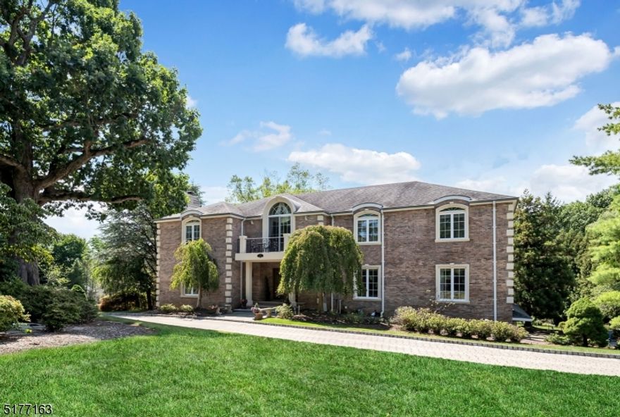 Majestic 5 bedroom Manor set on beautiful acre property offers a very special, peaceful and elegant retreat. Extensive custom millwork, archways and glorious views of the outside nature throughout. The grand two-story foyer with marble flooring welcomes you with awe and brings you to the formal living room with gas fireplace and accent lighting. French doors lead to the sun filled private library with walls of windows and coffered ceilings. The formal dining room boasts a butler's pantry which leads to the magnificent kitchen with glass door cabinetry, large island, 20 x 16 breakfast room with fireplace, and double French doors out to large private rear deck overlooking rear property. Spectacular two-story great room with fireplace and wet bar with a martini shaped custom sink, and floor to ceiling windows opens to an inviting sunroom with extra skylights and walls of windows. A convenient first floor bedroom suite offers a private full bath. The second floor features additional views to below and access to the primary bedroom with tray ceiling, large luxurious bath, and huge walk-in closet. Three more spacious bedrooms plus two more updated full baths. The walkout lower level is phenomenal with large windows and features a billiard/family room with fireplace, home theater, gym, guest space, sauna and full bath plus storage. Access to the three car heated garage. 4 Fireplaces! Truly gorgeous property.