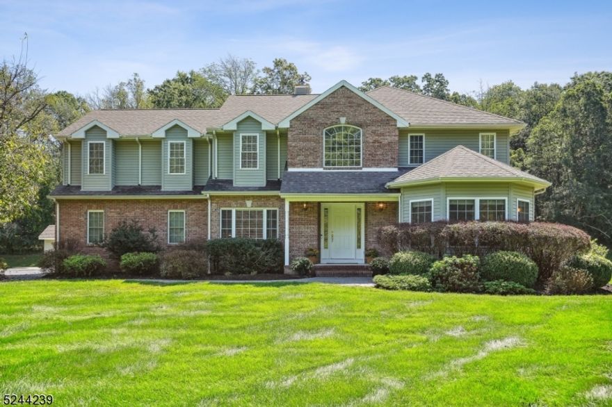 Gracefully situated on a 2-acre landscaped parcel, this colonial boasts exceptional features. Upon entry, gleaming hardwood floors and a 2-story foyer create a welcoming ambiance. Take note of the crown molding, recessed lighting, abundant natural light, generous windows, and 9-foot ceilings that enhance spaciousness throughout. The focal point is the gourmet kitchen with custom cabinetry, a spacious island, and distinct areas for everyday cooking and grand entertaining. Adjacent, a cozy den features a welcoming fireplace. The home includes a formal dining room for elegant dinner parties, formal living room, and a separate office space. Upstairs, the owner's suite is a private oasis with a tranquil sitting room. The suite offers a new spa-like bath with dual vanities, a soaking tub, and ample storage in the closet. Three generously sized bedrooms offer ample closet space and share a bathroom for convenience. The lower level has been updated to add valuable living space. It features a spacious recreation room, a new full bathroom, and a versatile exercise room that could convert to a fifth bedroom. Outside, an expansive deck invites al fresco dining, morning coffee, or relaxation amid natural beauty. Dual sheds provide ample storage for outdoor furniture and equipment. This prime property is just 6 minutes from town, offering serene living with easy access to amenities. Schedule a private showing and explore all this exceptional residence has to offer.