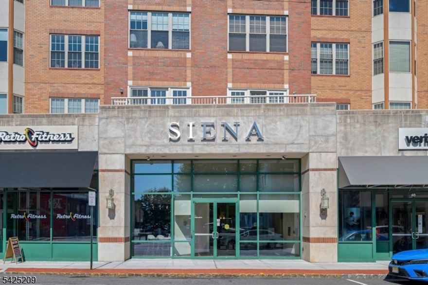 Experience luxury living in The Siena, a concierge-serviced building located in the heart of downtown Montclair.  This 5th floor unit looks westward, with a spectacular view of First Mountain.  A split-bedroom configuration provides privacy for both bedrooms, each with its own ensuite bath, plus a powder room for guests. Each bedroom has two closets, including a walk in in the primary. In the second bedroom, one closet is currently outfitted as a workspace with a built in desk but can easily be converted back. Eat-in kitchen has SS appliances and ample cabinets. Hardwood floors. Granite countertops in kitchen & baths.  Newer in-unit stackable Miele washer/dryer and LG refrigerator.  One assigned parking space (#97) in secure underground garage.  Residents enjoy a recently updated communal 6th-floor rooftop deck featuring multiple-seating areas and panoramic views of the NYC skyline and surrounding mountains. Leave your car at home and enjoy everything Montclair has to offer, from its wide range of restaurants, cafes, and boutiques to cultural highlights like the annual Jazz and Film Festivals, Art in the Park, and more.
