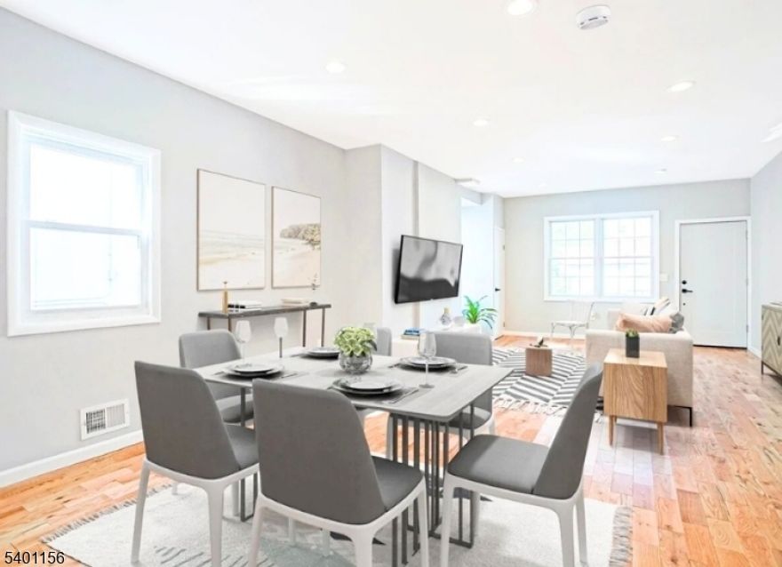 Step inside and experience a beautifully redesigned townhome where modern style meets warm, everyday comfort. The open concept layout welcomes you with sun-filled rooms, rich wooden flooring, and a seamless flow that makes the home feel spacious, inviting, and perfect for both relaxing and entertaining. This thoughtfully updated residence features 3 bedrooms, 2.5 bathrooms, a large private deck, bonus sunroom, finished basement, and a fenced yard, a rare combination of indoor and outdoor living in the heart of Jersey City. The showpiece kitchen is designed for both beauty and practicality, showcasing sleek stainless steel appliances, elegant white cabinetry, exposed brick chimney, accented backsplash, generous countertop space, and a stylish breakfast bar with open views into the living room, ideal for hosting and creating unforgettable moments. The home blends artistic touches with modern convenience throughout, with a washer and dryer located on the 2nd floor. Recessed lighting, custom tile work, and contemporary fixtures add personality and charm, while the newly designed bathrooms offer a fresh, spa like feel. Located just steps from the Light Rail, Berry Lane Park, and the energy of Downtown Bergen-Lafayette, this property places you in one of Jersey City's fastest growing and most sought-after neighborhoods. Enjoy parks, community gardens, caf s, culture, and effortless commuting all right outside your door. Home maybe eligible for a grant through our approved lenders.