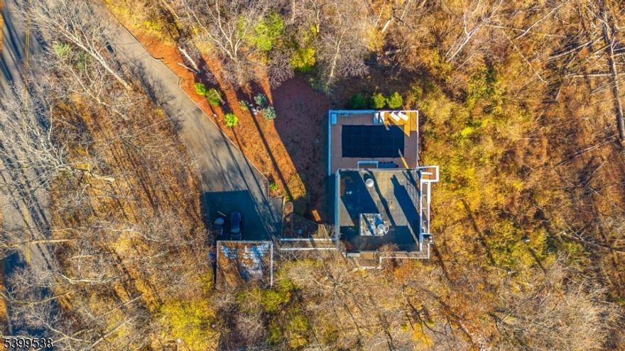 A rare architectural offering, this custom modernist residence channels the iconic work of Gwathmey Siegel with its sculptural geometry, minimalist lines, and sweeping walls of glass. Built in 1978 and brilliantly sited to capture panoramic skyline views, the home is bathed in natural light and wrapped in terraces, creating a seamless connection to the outdoors. A multi-story great room serves as the centerpiece framed by towering windows, a sculptural staircase, and one of 3 wood-burning fireplaces. The open dining and living areas flow onto the deck for year-round entertaining, while the kitchen retains its original vintage charm with a built-in booth, expansive counter space, and track lighting. Upstairs living spaces unfold with elegance: a lofted sitting area within a sun-filled bedroom suite, and a private rooftop office with direct access to the flat roof for outdoor gatherings. The primary suite is its own retreat with fireplace, balcony, and spa-like bathroom. The finished walk-out basement extends the home's versatility with three additional bedrooms, a full bath, and a sprawling family room anchored by another wood-burning fireplace. Throughout the home, signature details pay homage to the era and elevate everyday living. Outdoors, your private resort awaits: a heated in-ground pool, wraparound terrace, multiple decks, balcony, and soaring views. Numerous recent updates complete the exceptional package. This modern masterpiece offers an unmatched opportunity.