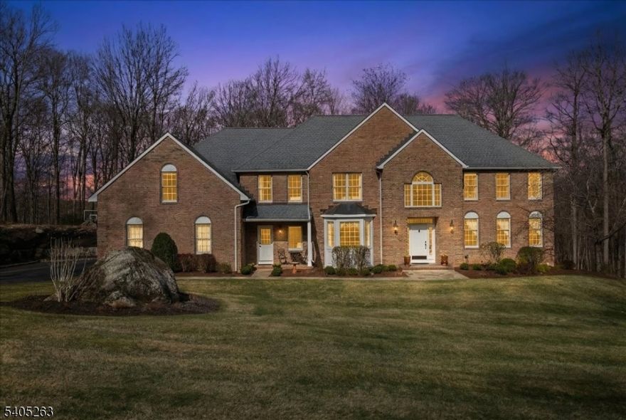 Welcome to this spacious and elegant 4+ bedroom, 3.5 bath colonial set on beautiful park-like grounds, conveniently located near town, schools, and commuter routes. The main level features a formal living room and dining room, a sun-filled oversized family room with a wood-burning fireplace, and a versatile office/bedroom/den with a fully renovated modern bath. The remodeled kitchen offers quartz countertops, updated appliances, an oversized center island, a separate bar area, and a spacious eating area overlooking the private two-tier backyard patio with fire pit. The second level includes an oversized primary suite and an en-suite bath.  Down the hall is an updated bathroom, 3 bedrooms, plus a possible 4th bedroom and a bonus/recreation room. Recent updates include a new driveway, updated front sidewalk, and newer central air units. Additional features include an irrigation system, oversized high-bay three-car garage with generator hookup, first-floor laundry/mudroom, central vacuum, back staircase to the second level, and a walk-out basement.   If you are looking for space, flexibility, thoughtful updates, and a convenient location - Welcome Home!