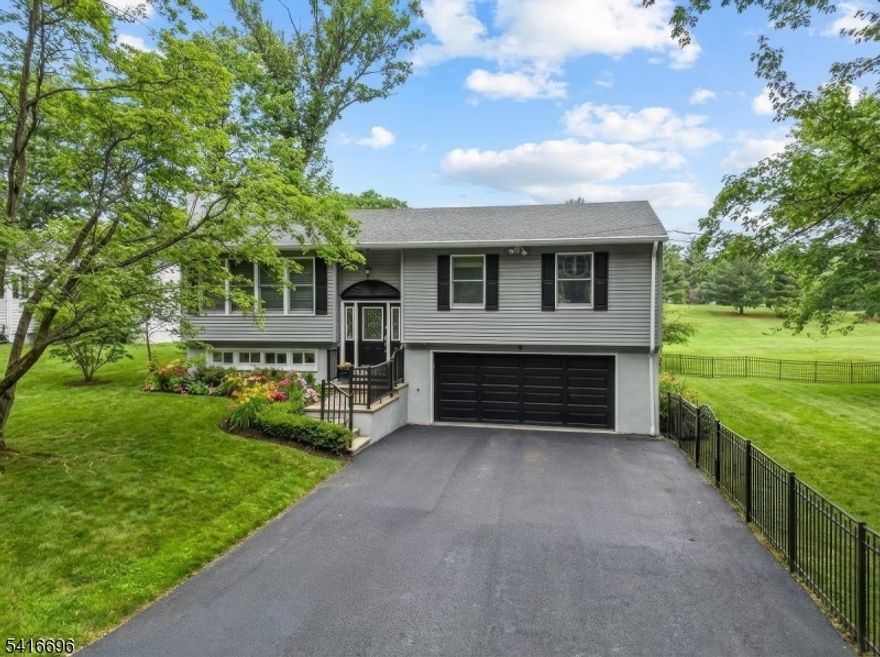 Set along the Lake Mohawk Golf Course, this beautifully maintained home offers an open floor plan with 3 bedrooms and 2.1 baths, blending comfort, style, and thoughtful updates throughout. Major improvements include a newer septic, roof, siding, garage doors, kitchen, deck, and slider providing peace of mind and move-in-ready ease. The kitchen features white cabinetry with pullout shelving, solid surface counters, stainless steel appliances, and a convenient breakfast bar, opening seamlessly to the main living spaces. Hardwood flooring, crown molding, and plantation shutters on the expansive living room window add warmth and character. The walkout basement features radiant heat and a cozy wood-burning fireplace, offering flexible space for recreation, work, or relaxation. Outside, a rare fenced double lot provides ample room for entertaining, play, or simply enjoying the scenic golf course setting.