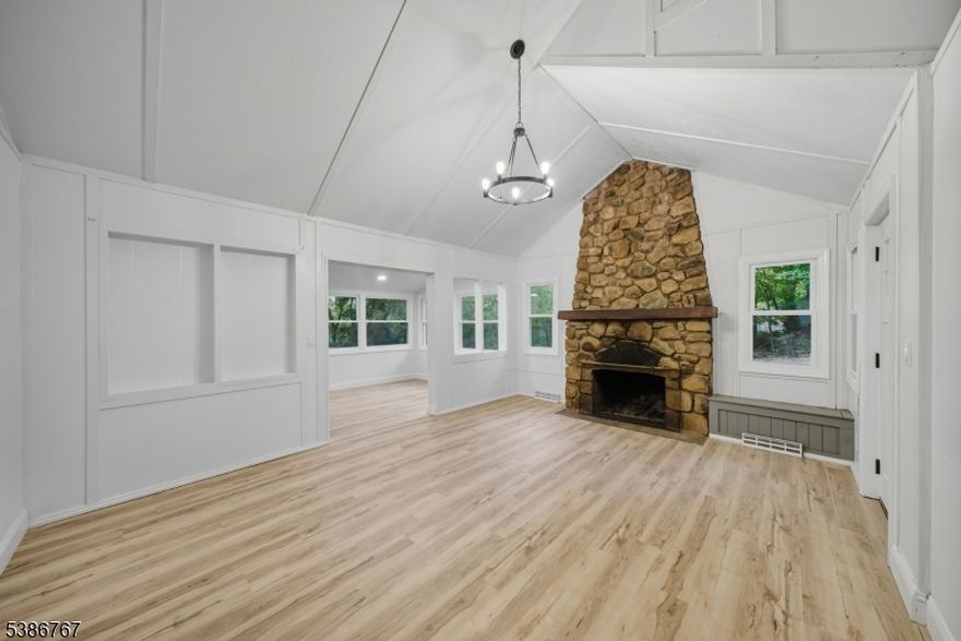 Welcome to this updated, charming home tucked away in Sussex County's most coveted gem, Lake Mohawk. From the moment you drive through this tranquil and picturesque community, you will want to call it Home. The inviting front porch sets the tone for the warmth + character you'll find inside. The living room impresses with cathedral ceilings + stunning stone wood-burning fireplace, balanced by built-in storage and brand-new flooring that flows seamlessly throughout the home. The updated eat-in kitchen is a true highlight, filled with natural light and featuring modern butcher block countertops, stylish new cabinetry, and new appliances. A unique balcony door extends the living space outdoors, where you can enjoy peaceful scenery + even seasonal views of the lake. Two spacious bedrooms, one of which has a loft! The side yard offers ample room for entertaining, gardening, or relaxing in nature, while practical updates such as public water and a Roth oil tank provide peace of mind. Life in Lake Mohawk brings not only serenity but also access to the many amenities this private lake community is known for, including a country club, beaches, boardwalk, clubhouse dining. White Deer Plaza is just mins. away, a beautiful downtown area with European influences, + an abundance of charming restaurants + shops. Whether you are seeking a year-round residence or a weekend retreat, this beautifully updated home combines rustic charm, modern convenience, + the unique lifestyle of Lake Mohawk.