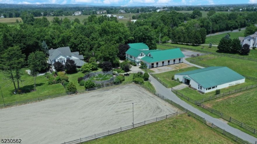 Welcome to Meadow Creek Farm! This beautifully maintained 26-acre property offers a multitude of impressive features including a modern Farmhouse Colonial w/ in-law suite, a charming carriage house, horse facilities, professional workshop w/ heat/ac, and an oversized 9+ car garage. The home features a rocking chair front porch and gazebo, a custom-designed chef's kitchen, craftsman quality cabinetry, granite countertops, 20-ft island, and commercial-grade appliances. Dining Room flows into kitchen with built-in cabinets, wood-burning fireplace, stone accents, and wine niche. Living Room impresses w/ vaulted ceilings, timber frame accents, gas fireplace, quality craftsman millwork throughout home. On the second floor you'll discover a primary suite w/ dressing area/walk in closets, and a luxurious bathroom featuring sauna, steam shower and jetted tub. Two additional bedrooms and a full bathroom. The first-floor in-law suite includes a kitchen, dining area, 2 bedrooms and separate entrance providing flexibility for multi-generational living. Horse Facilities: Two barns w/ a total of 17 stalls, 2 wash stalls w/ hot/ cold water, spacious tack/ feed rooms, numerous storage areas, bathroom, and laundry. Outdoor riding accommodations: Lighted 100x200 riding arena, stone dust/sand footing, European hot walker w/ rubberized footing, 8 turnout paddocks, 10x24 run-in shed, hay loft, separate gated driveway. Turnkey facilities perfect for horse boarding/training or other farm endeavors.