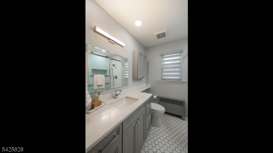 Nestled in the highly sought-after Wychwood section of Westfield, this stunning, meticulously maintained ranch offers the perfect blend of luxury, comfort, and effortless living. This home delivers both convenience and charm in one exceptional package. Step inside and experience a wonderful flow with thoughtfully designed living spaces that feel both open and inviting. The sun-filled living room is centered around a warm gas fireplace and opens seamlessly to a generously sized dining room. A remodeled bathroom showcases classic tile and high-end fixtures, offering a luxurious, spa-like retreat. All bedrooms are spacious and offer fitted custom California Closets. The lower level expands the home's versatility with a grand family room, full bathroom, cedar closets and abundant storage. Every detail has been considered from Andersen replacement windows and newer roof to modern upgrades including enhanced electrical service, a plug-in for an electric vehicle, a whole-house Kohler generator & security system with alarmed garage. Outdoor living features Trex deck, bluestone patio, and a charming pergola perfect for entertaining. A striking stone retaining wall frames the property beautifully. The oversized tandem garage accommodates two vehicles and includes exceptional storage. Enjoy close proximity to downtown and NYC transportation making everyday living seamless. Move right in, unpack, and experience the warmth of a welcoming community in a home that truly has it all.