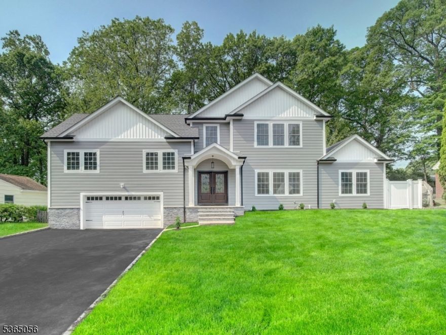 Completely renovated in 2025, and never lived in, welcome to this all new, truly unique 5 bedroom, 4.5 bathroom home in highly-desirable Mountainside. The living room is colossal in size easily accommodating large gatherings without sacrificing flow or comfort. Adjacent, the gorgeous. modern chef's kitchen is anchored by a substantial island with breakfast bar and features an abundance of cabinetry and brand-new Kitchen Aid appliances. As an added bonus full en suite bedroom on the first floor.  A formal dining room and a powder room complete the first floor. The second floor features three spacious bedrooms, one with an attached bath, plus an additional full bathroom. On the third level you will find the Primary En Suite bedroom containing a massive walk-in closet, and a full bath featuring a beautiful soaking tub and oversized, glass-enclosed walk-in shower. Also on this level is the laundry room with Whirpool appliances, and a well-positioned home office. The full-finished basement is expansive, ideal for a home gym, playroom, media space, or all three. Outside, a fenced-in, tree-lined backyard and oversized deck, perfect backdrop for both quiet mornings and entertaining guests. Other items of note: NEW roof, NEW A/C and furnace, NEW everything. Super close to all major highways, shopping, fine dining. This home doesn't try to impress. It simply delivers quietly, confidently, and completely. Some rooms virtually staged.