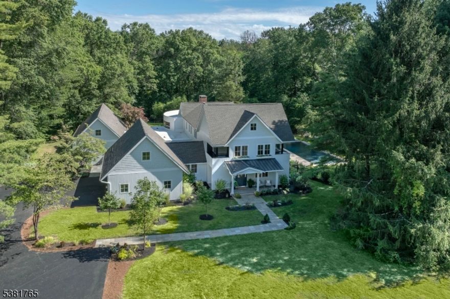 Completely reconstructed in 2025, this custom-designed, turnkey home resides on four level acres within a private, tree-lined cul-de-sac in Harding Township. The home features five bedrooms and six bathrooms across light-filled interiors with custom finishes, wide-plank oak floors, and soaring ceilings. Oversized windows frame views of a refreshing lap pool, limestone terraces, and gardens. The home opens to a bright foyer with a classic switchback staircase spanning three levels, adjacent to a powder room and a mudroom, with clear sightlines to the coffered-ceiling parlor/library. The spacious chef's kitchen boasts Sub-Zero and Wolf appliances, custom cabinetry, and a large pantry. It adjoins a family room with dramatic 20-foot ceilings and a fireplace, an elegant dining room with a wet bar butlery, as well as a screened-in outdoor porch and patio area. A private first-floor primary wing offers spa-inspired luxury. The home is located minutes from acclaimed schools and the vibrant town centers of Morristown, Madison, Chatham, and Bernardsville. It is accessible to NYC via NJ Transit, in close proximity to I-287, and near Boxcar bus stops. The home includes a 10-year warranty.