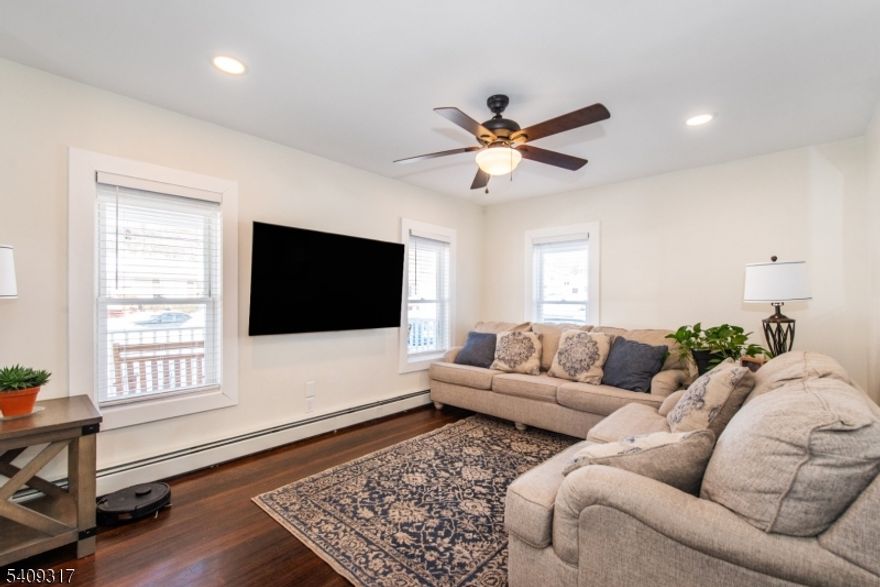 Great opportunity, beautifully updated, and a large level property- Welcome home! The fully updated interior features 3 bedrooms and 1.5 baths. An inviting foyer leads into spacious living room with hardwood floors that continue into the charming formal dining room. The tastefully updated eat-in kitchen offers porcelain tile flooring, quartz countertops, and breakfast area. Wonderful multi-use bonus room that can be used as a mudroom, home office, or flex space. An updated half bath completes the main level. The second floor offers nicely sized bedrooms filled with natural light and an updated full main bath. Additional attributes include: recessed lighting, hardwood floors. Laundry is located in the unfinished basement, which also provides ample storage space. Enjoy the deep, level yard with a stone patio, perfect for entertaining, along with a charming front lemonade porch ideal for relaxing on warm summer nights. Great location: within minutes distance to downtown Sussex, NJ Transit bus, parks and major highways.